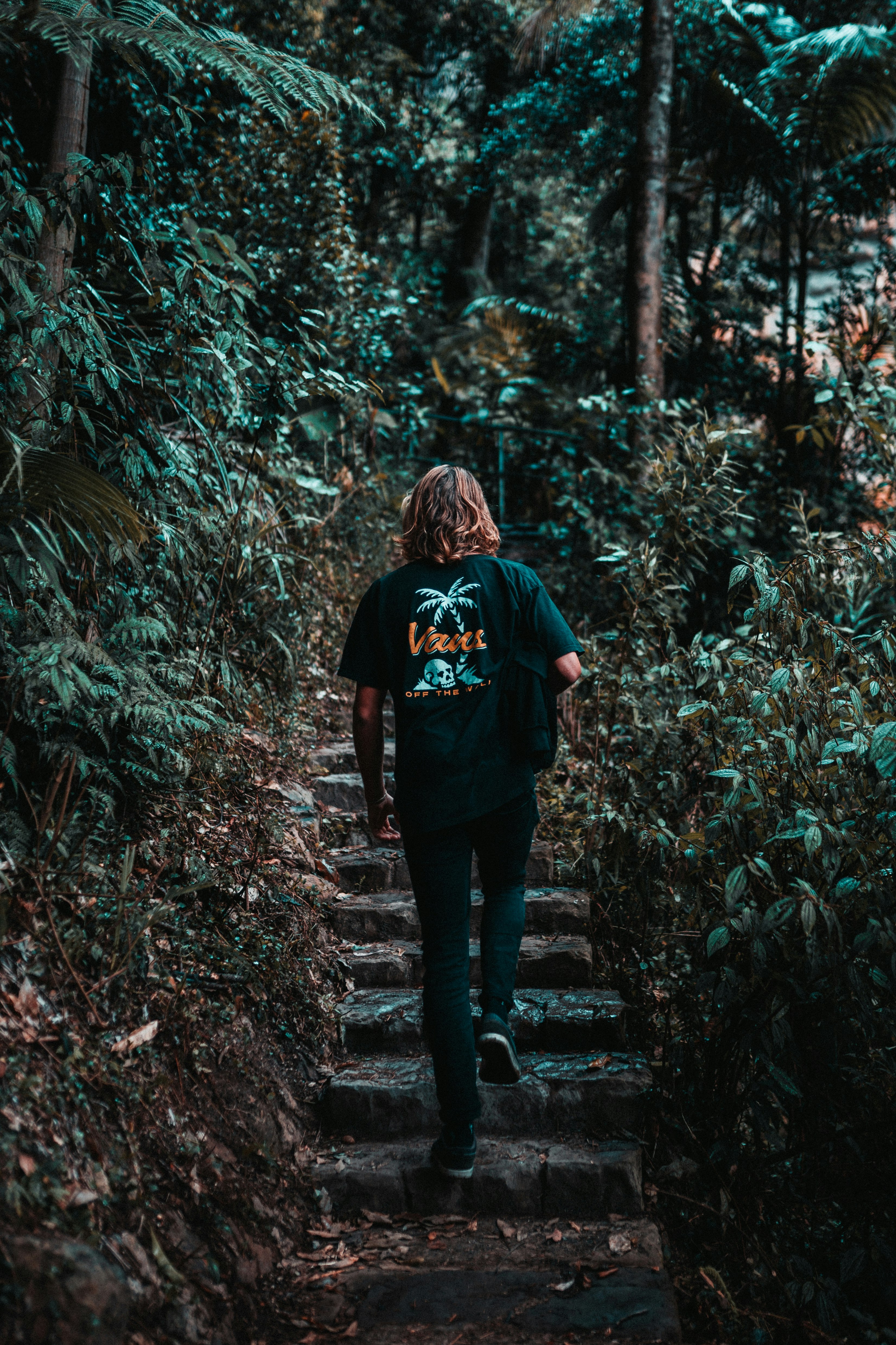 woman in black jacket standing on forest during daytime